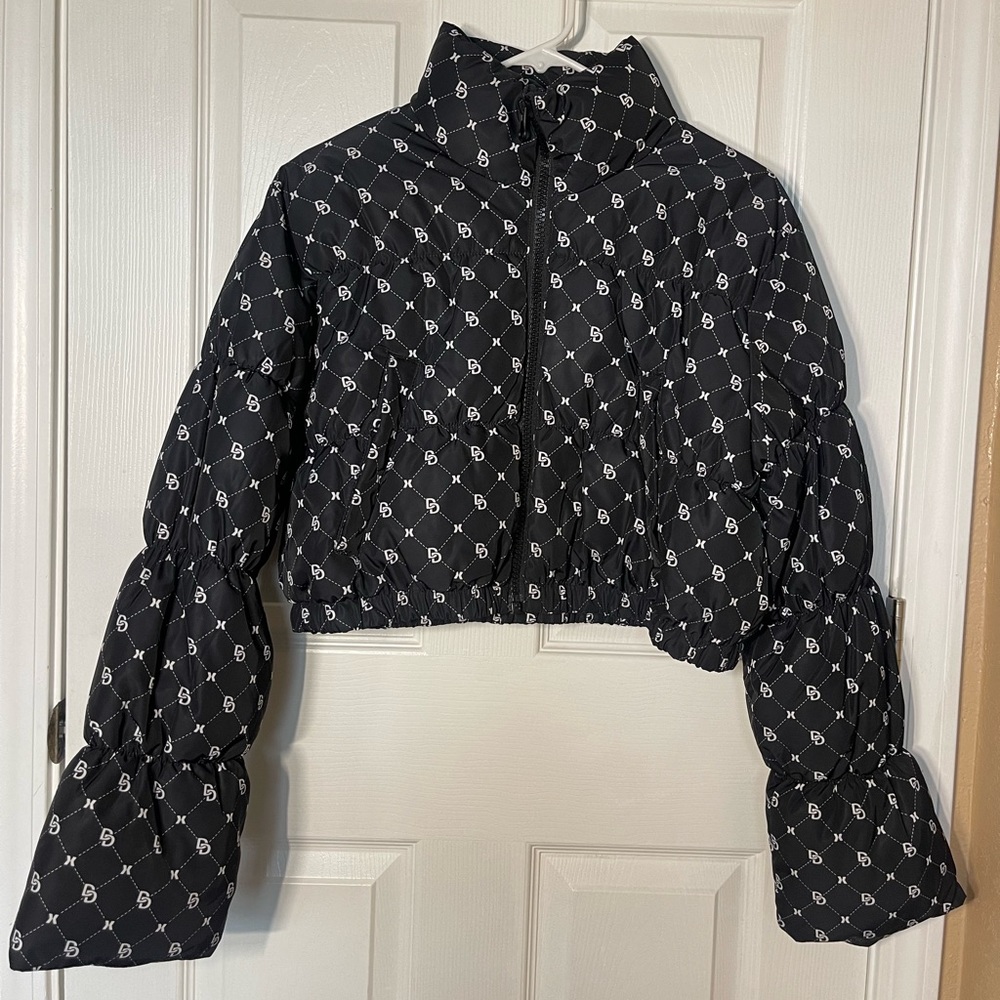 Crop Puffer Jacket in color Black with white lettering size Medium.
